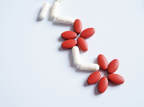 Red and white pills for medical treatment, Pain relief and blood tonic.