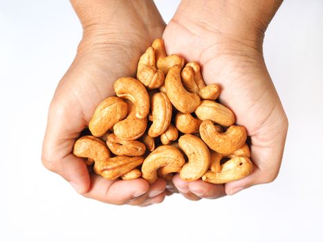 Above of hand with cashew nuts. isolated on white background.