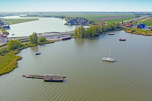 Aerial from a typical dutch landscape in the countryside from the Netherlands with a flat landscape and lakes 