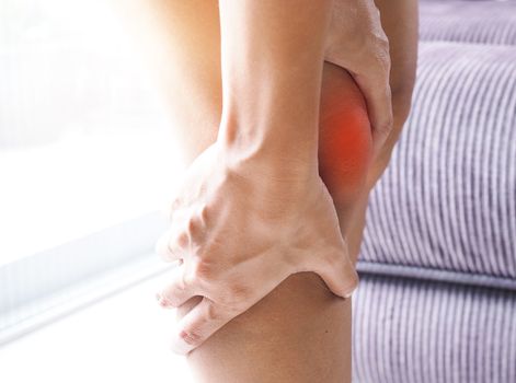 Close-up of Asian women with knee and leg pain By using hands to massage body to relieve pain