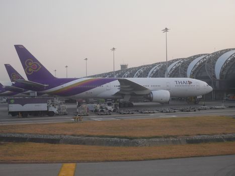 BANGKOK, THAILAND -12 MARCH 2017- Airplanes from Thai Airways (TG), the flag carrier of Thailand and a member of Star Alliance, are parked at their hub at the Suvarnabhumi Airport (BKK) in Bangkok.