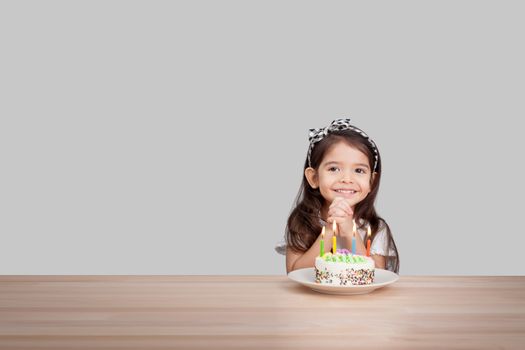 cute girl make a wish on birthday. Happy Birthday background. Greeting background for card, flyer, poster, sign, banner, web, postcard, invitation. Abstract fest background for text, type, quote
