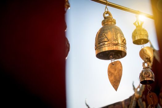 Small bell for pray decorate around Thai buddha temple with sunrise at Doi suthep landmark  for tourist in Chiang Mai province , Thailand