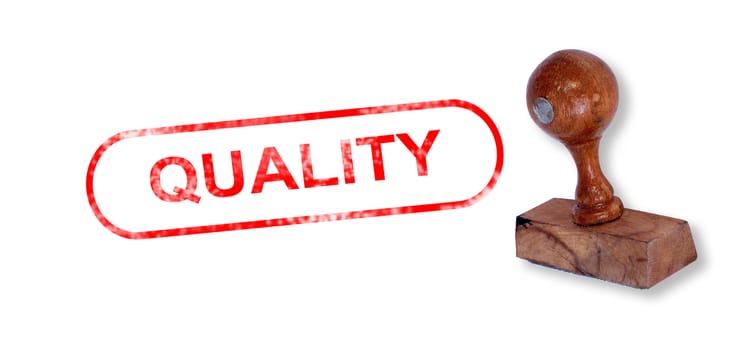 Top view of a rubber stamp with a giant word "QUALITY" printed, isolated on white background.