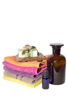 soap on top of facecloths of various shades with bottles