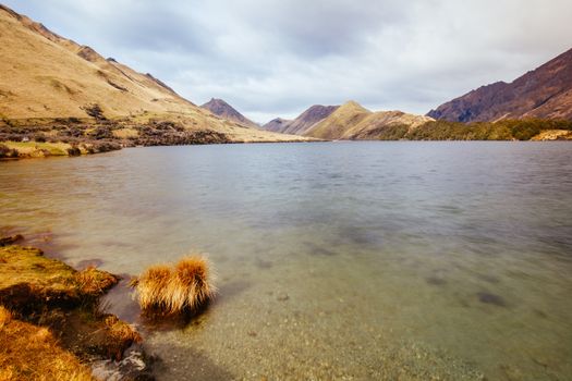 The stunning idyllic Moke Lake near Queenstown in Otago, New Zealand. This secluded, peaceful lake is a popular locale for camping, boating, hiking and horseback riding.