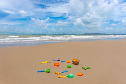 Many colorful sand toy on the white sand beach at summer time.