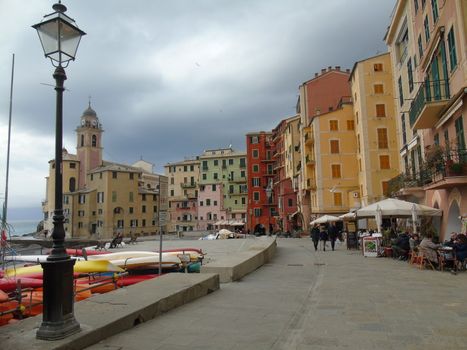 Liguria, Italy - 06/15/2020: Travelling around the ligurian seaside. Panoramic view to the seaside and the old villages. An amazing caption of the medieval coloured houses with grey sky in the background.