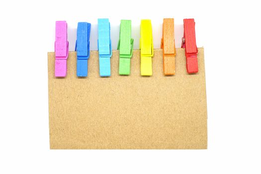 Isolated Brown notepad with colorful clip on white background.
