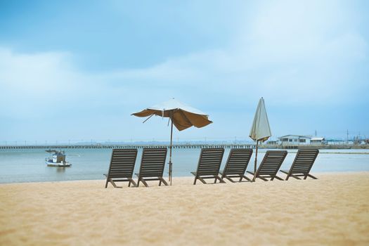 Beach chairs on sand beach in Pattaya, Chonburi, Thailand.