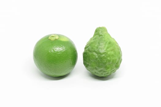 Fresh green Kaffir bergamot and lime fruit isolated on white background, two fruits are important ingredient of food in Asia.