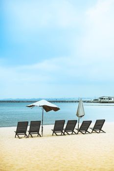 Beach chairs on sand beach in Pattaya, Chonburi, Thailand.