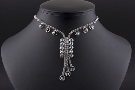 Diamond necklace on a black display stand