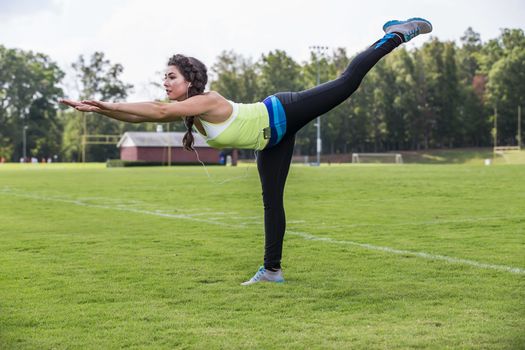 A gorgeous blonde fitness model working out in an outdoor environment