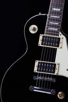 A classic black electric guitar body with white scratchplate