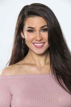 A gorgeous brunette model posing in a studio environment
