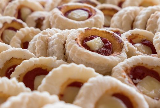 Group of Small pizzas with mozzarella and tomato. Traditional and famous Italian plate. In particular, mini pizzas, are used as aperitifs in parties and events. Shallow depth of field.