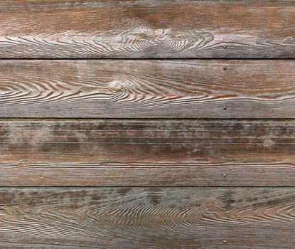 Surface of dark roughly polished wooden boards