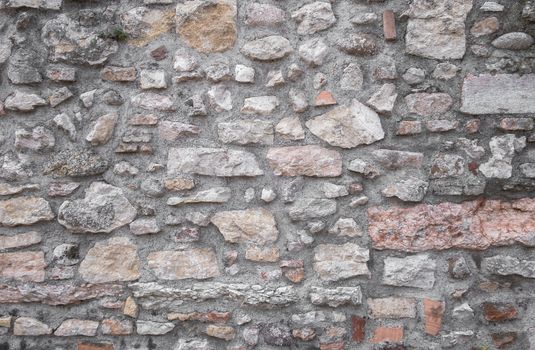 Background of old natural stone wall. Ideal for backgrounds and textures.