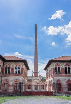 Entrance to the factory of Crespi d'Adda. The entrance is characterized by the so-called "red gates" in wrought iron. Crespi d'Adda / Capriate San Gervasio (BG) Italy - June 15 2018.