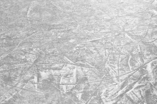 Ice rink floor, detail of a textured background ice. Sports and seasons.