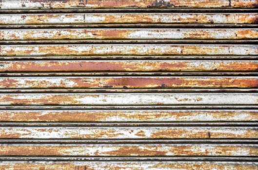 Background photo of a rusty old iron rolling shutter. Ideal for your grungy creative background.