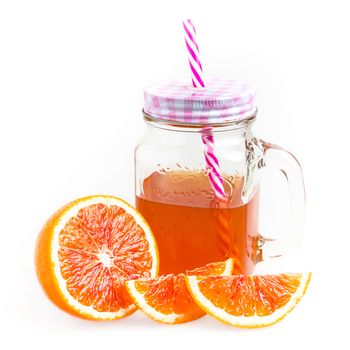 Mason jar glass of tea with oranges isolated on a white background