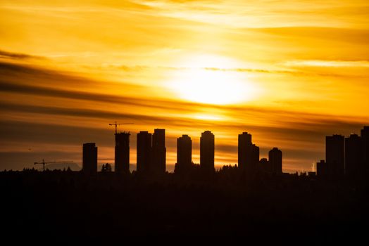 Metrotown silhouette on sunset cloudy sky background