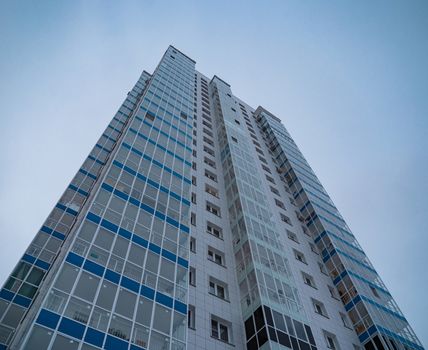 New highrise residential tower on blue sky background