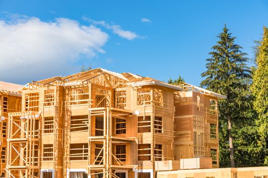 New apartment building under construction with two trunks of timber stored on side