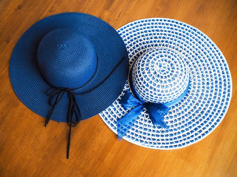Top view of blue wide brimmed straw hat, summer fashion of women.