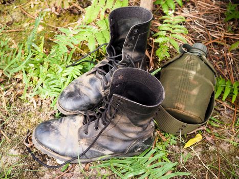 Military boots or men combat shoes and water bottles Or equipment for hiking