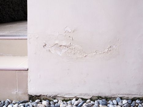 damaged house wall and water stains with broken color and crack,