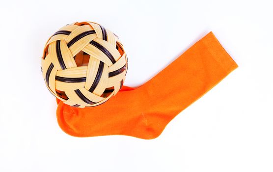 Sepak Takraw ball and orange socks For sports, exercise. Isolated on a white background.