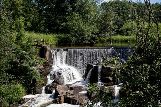 Small waterfall of dam in forest