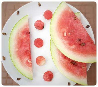 Chill pink color slices of watermelon with round shape cut pieces in white plate and good drink for summer days and healthy fruit and also to keep body hydrate drink