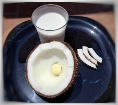 Coconut milk with coconut flower in black plate is Rich in fiber stable blood sugar and good for heart It may also boost weight loss