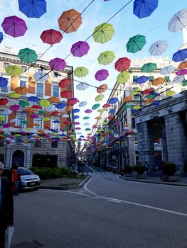 Genova, Italy - 06/01/2020: Bright abstract background of jumble of rainbow colored umbrellas over the city celebrating gay pride