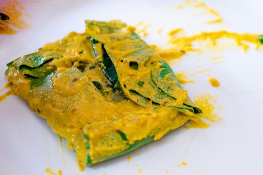 Beautiful Arvi colocasia root leaves coated with flour gram and turmeric paste and wrapped and tied ready for frying. This is a popular dish in North india especially in cities like Mumbai, Delhi and other to make pakode bhajiya and more