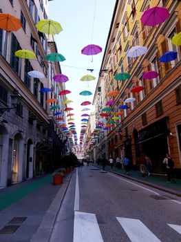 Genova, Italy - 06/01/2020: Bright abstract background of jumble of rainbow colored umbrellas over the city celebrating gay pride