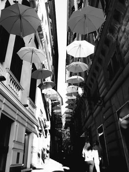 Genova, Italy - 06/01/2020: Bright abstract background of jumble of rainbow colored umbrellas over the city celebrating gay pride