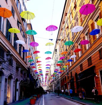 Genova, Italy - 06/01/2020: Bright abstract background of jumble of rainbow colored umbrellas over the city celebrating gay pride