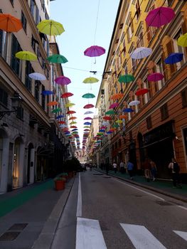 Genova, Italy - 06/01/2020: Bright abstract background of jumble of rainbow colored umbrellas over the city celebrating gay pride