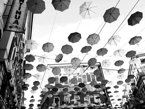 Genova, Italy - 06/01/2020: Bright abstract background of jumble of rainbow colored umbrellas over the city celebrating gay pride