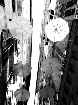 Genova, Italy - 06/01/2020: Bright abstract background of jumble of rainbow colored umbrellas over the city celebrating gay pride