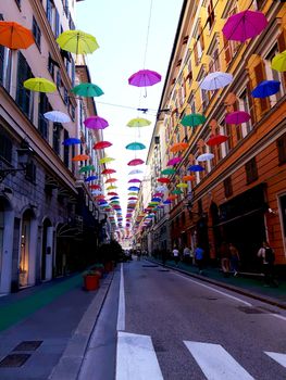 Genova, Italy - 06/01/2020: Bright abstract background of jumble of rainbow colored umbrellas over the city celebrating gay pride