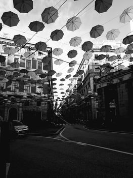 Genova, Italy - 06/01/2020: Bright abstract background of jumble of rainbow colored umbrellas over the city celebrating gay pride