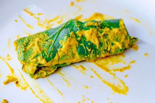 Beautiful Arvi colocasia root leaves coated with flour gram and turmeric paste and wrapped and tied ready for frying. This is a popular dish in North india especially in cities like Mumbai, Delhi and other to make pakode bhajiya and more