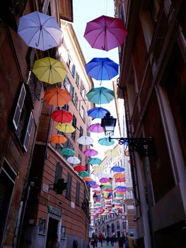 Genova, Italy - 06/01/2020: Bright abstract background of jumble of rainbow colored umbrellas over the city celebrating gay pride