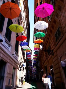 Genova, Italy - 06/01/2020: Bright abstract background of jumble of rainbow colored umbrellas over the city celebrating gay pride